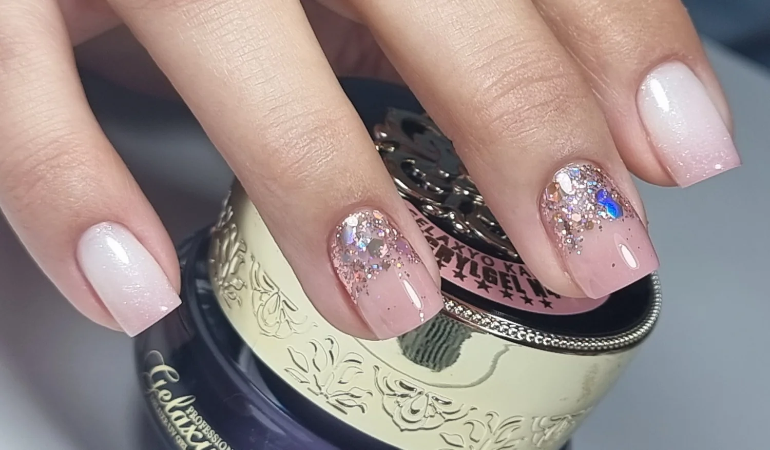 A finished pink and glitter manicure by SG Beauty & Nails Studio